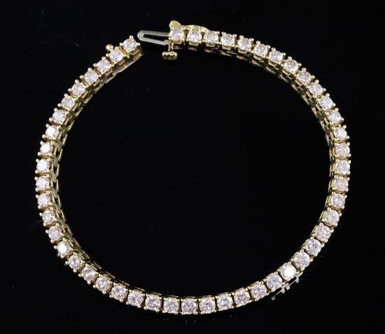 An 18k gold and diamond line bracelet, 17.5cm.